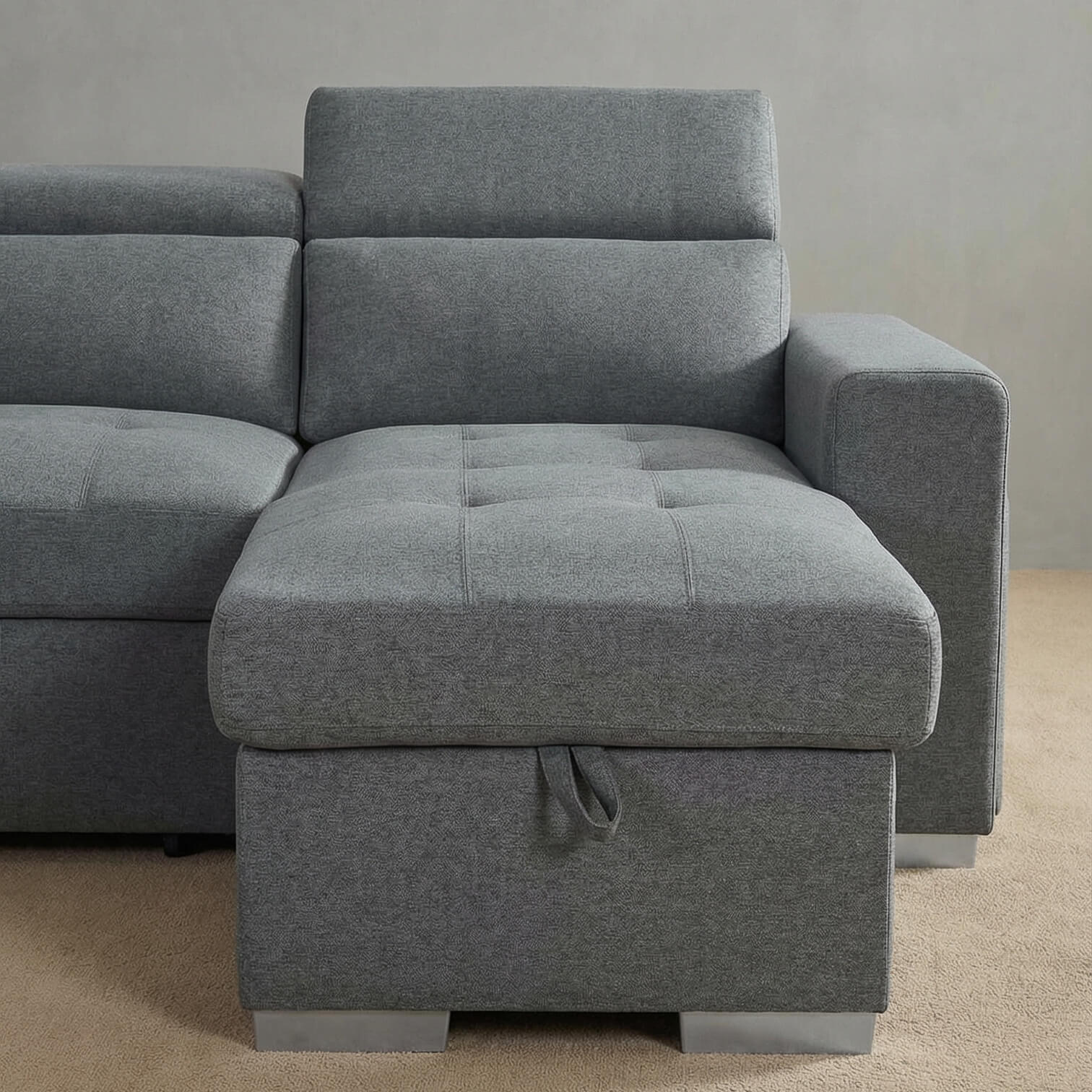 Grey corner sofa bed with ottoman lift on a beige carpet