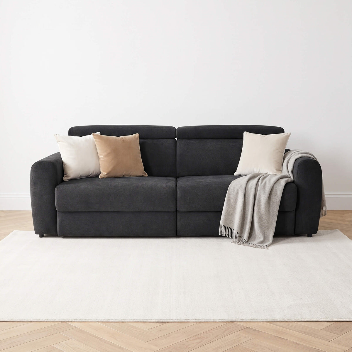 Flex Black 3 Seater Power Slider Sofa with cream cushions and grey throw in a bright modern living room