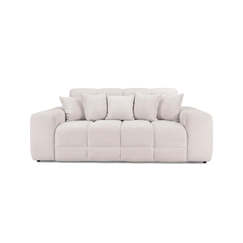 Beige three-seater sofa with tufted back and seat cushions