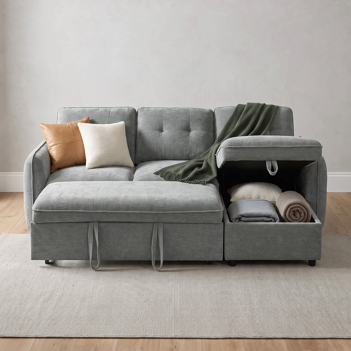Grey corner sofa bed with tufted cushions, reversible arm, and open storage compartment