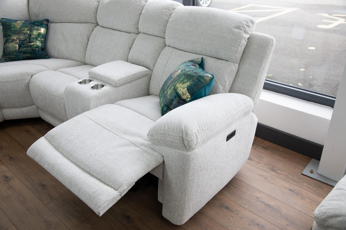Beige corner recliner sofa with extended chaise and padded arm console with cup holders