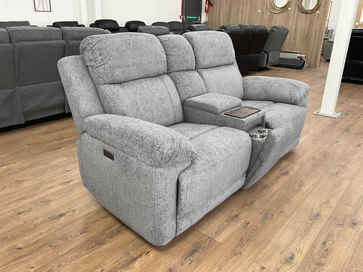 Grey fabric 2-seater power recliner sofa with extended footrest and console panel.