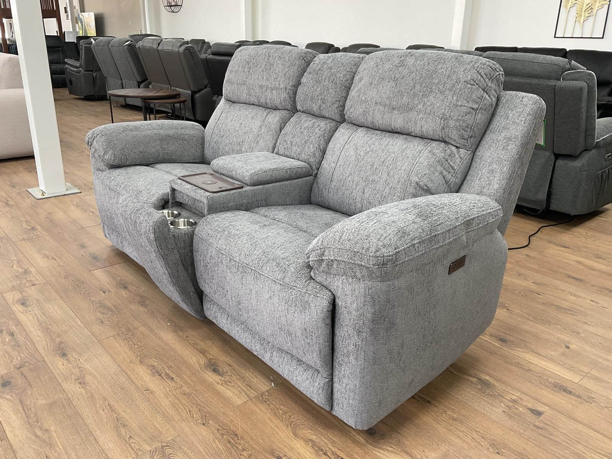 Grey 2-seater power recliner sofa angled view with cushioned armrests and base.