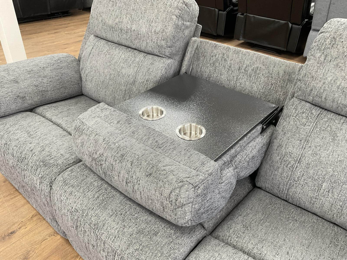Grey power recliner sofa with center console cup holders on the armrest tray