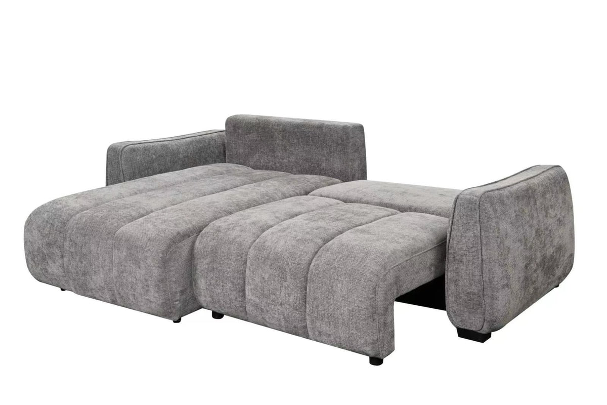 Grey corner sofa bed with extended chaise, plush seat cushions and tall backrest.