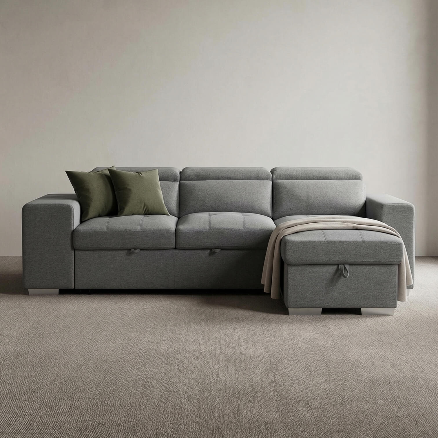 Grey corner sofa bed with a blanket and pillows in a minimalistic room.