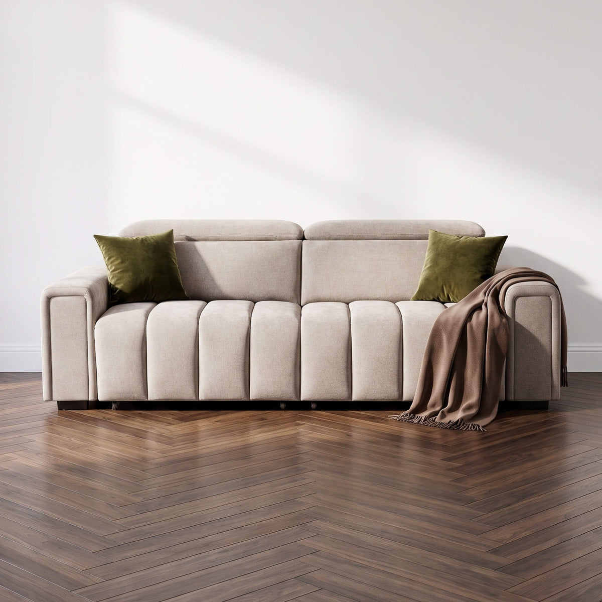 Beige 3-seater sofa with square cushions, green pillows, and folded throw blanket