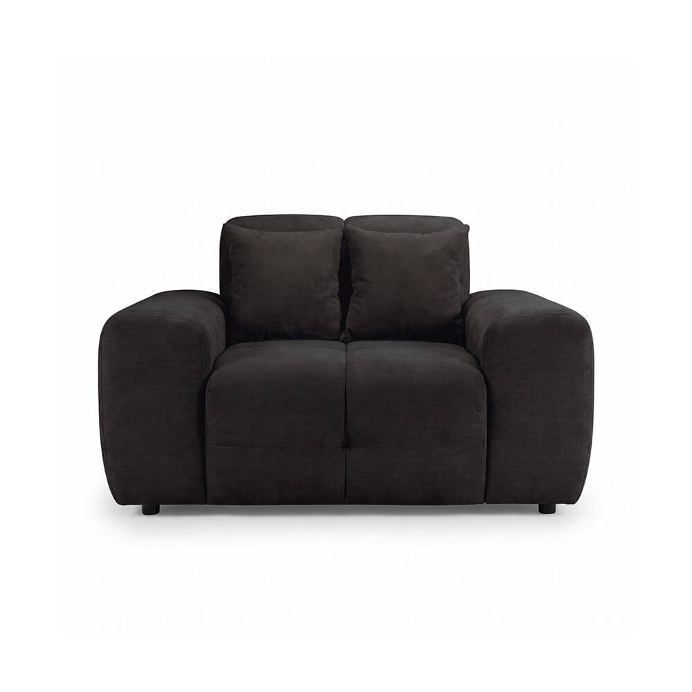 Dark fabric armchair with two back pillows, tufted seat, and short black legs