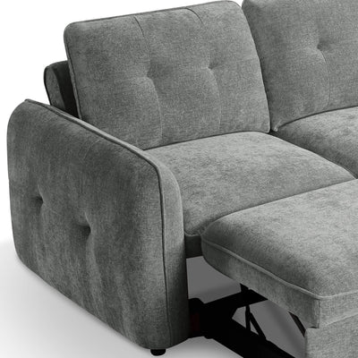Grey corner sofa bed close-up with tufted arms and pull-out bed frame beneath