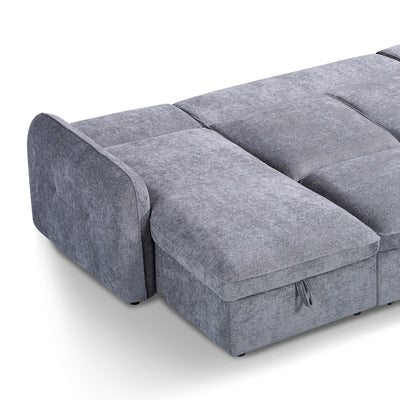 Grey sofa bed chaise with padded seat segments and skirted base on short legs