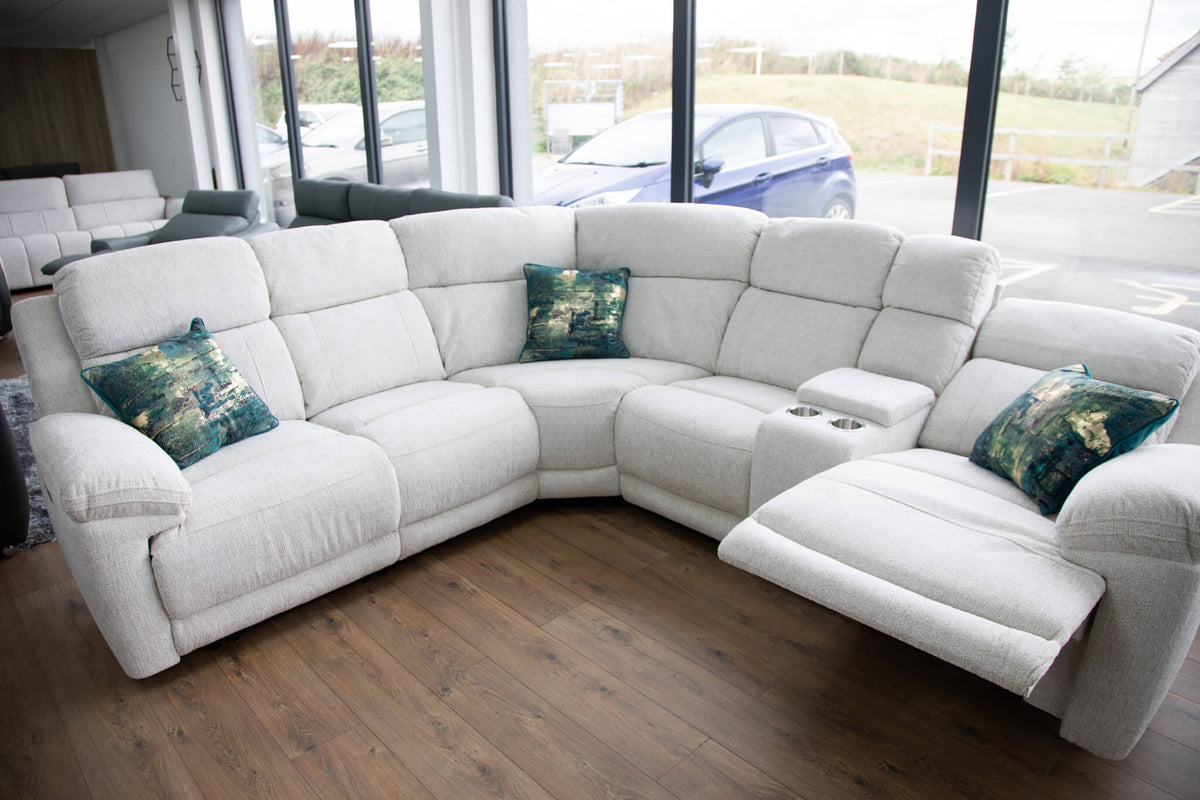 Beige corner recliner sectional sofa with chaise, padded arms, and console cup holder