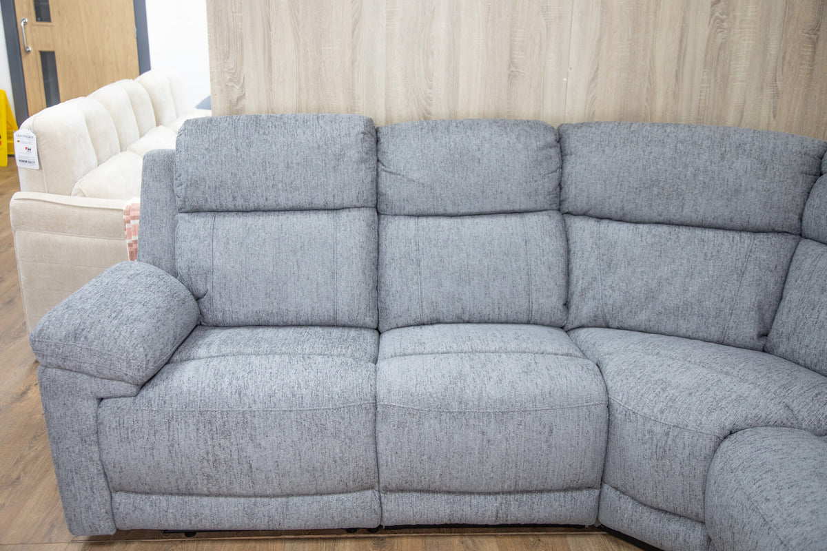 Grey 3-seat recliner sofa with padded arms, segmented back, and clean upholstery