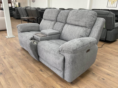 Grey 2-seater power recliner sofa angled view with cushioned armrests and base.