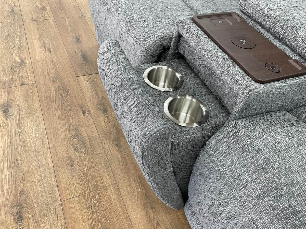 Power recliner sofa side detail: cupholders and control panel on the arm console.