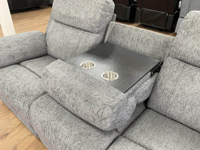 Grey power recliner sofa with center console cup holders on the armrest tray