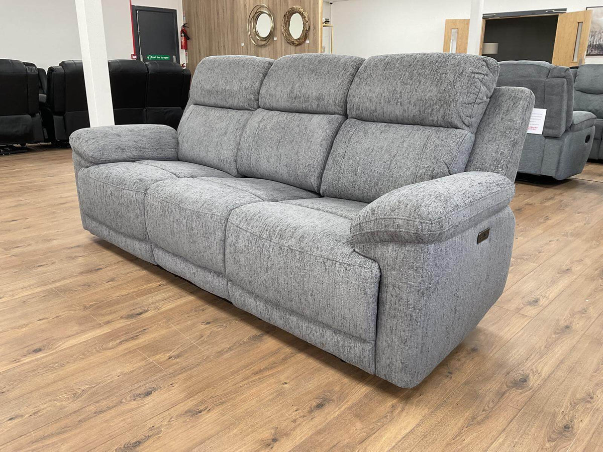 Grey fabric power recliner sofa with padded arms, three-seat back, and recliner base