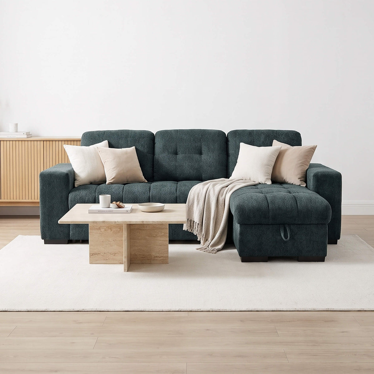 Teal corner sofa bed with tufted cushions, beige throw pillows and open chaise