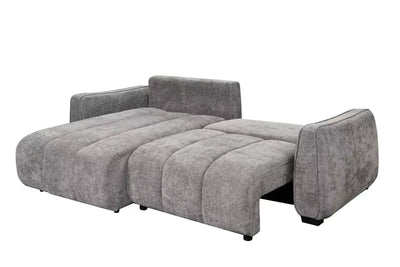 Grey corner sofa bed with extended chaise, plush seat cushions and tall backrest.