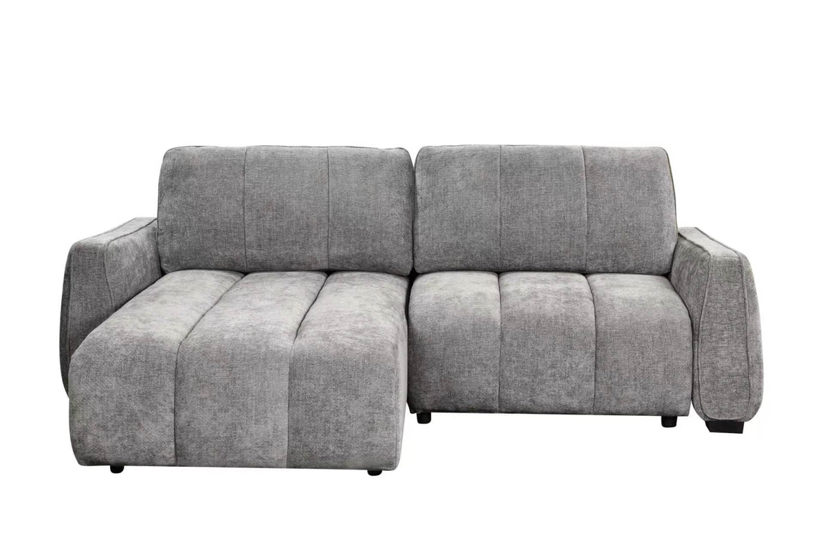Grey corner sofa bed with chaise section, padded armrests and tufted back cushions.