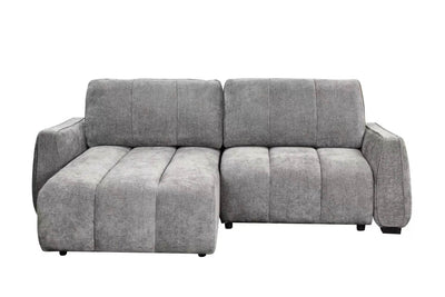 Grey corner sofa bed with chaise section, padded armrests and tufted back cushions.